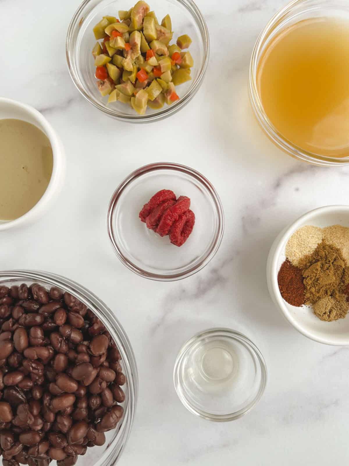 overhead view of bowls containing ingredients for spicy black beans