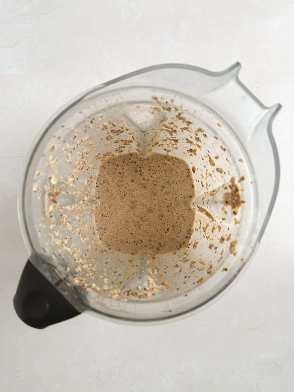 overhead view of blender containing blended ingredients for chai overnight oats