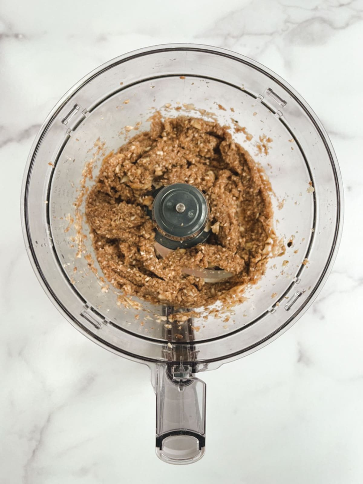 overhead view of food processor containing pulsed mushrooms