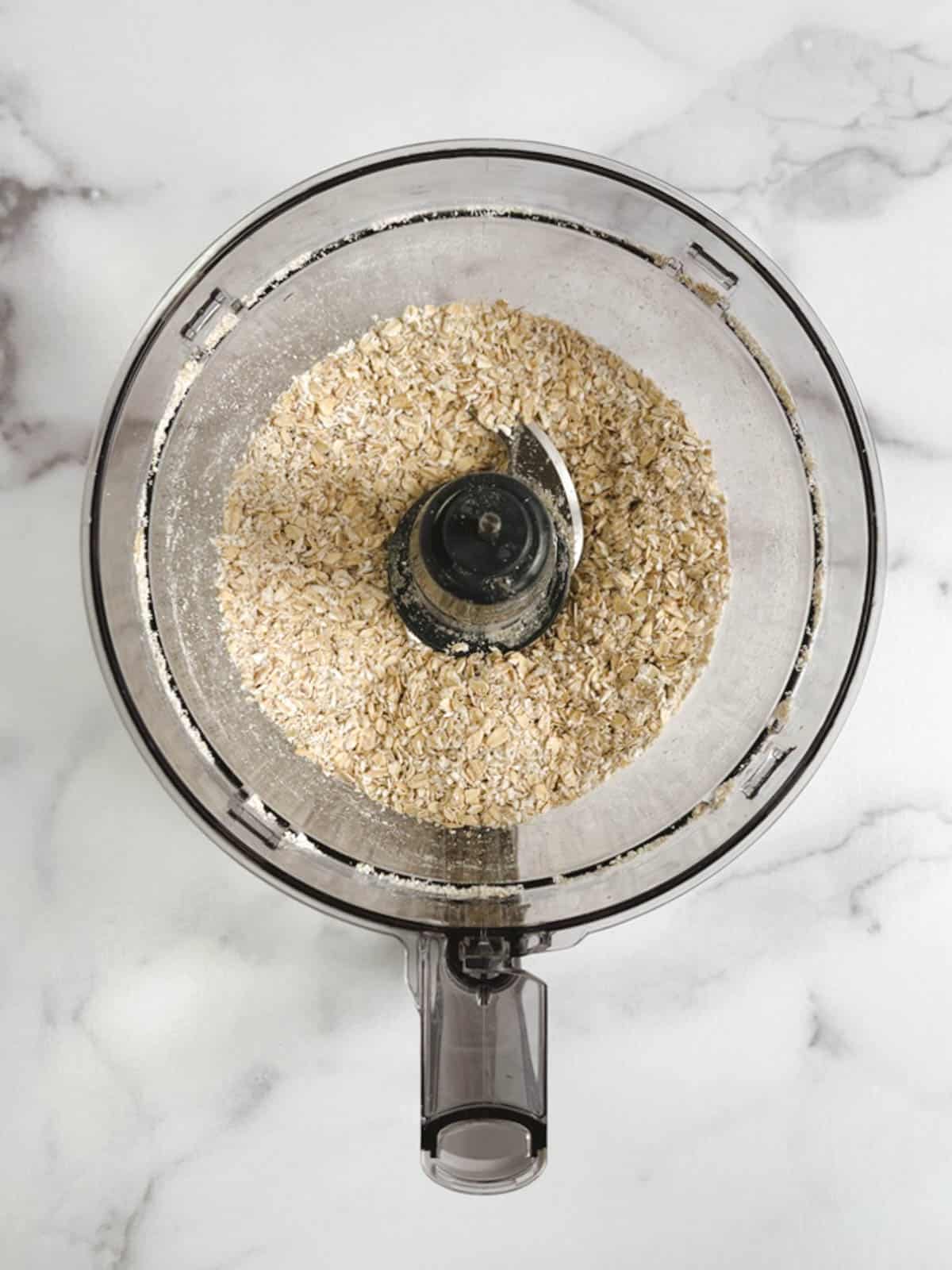 overhead view of food processor containing pulsed oats