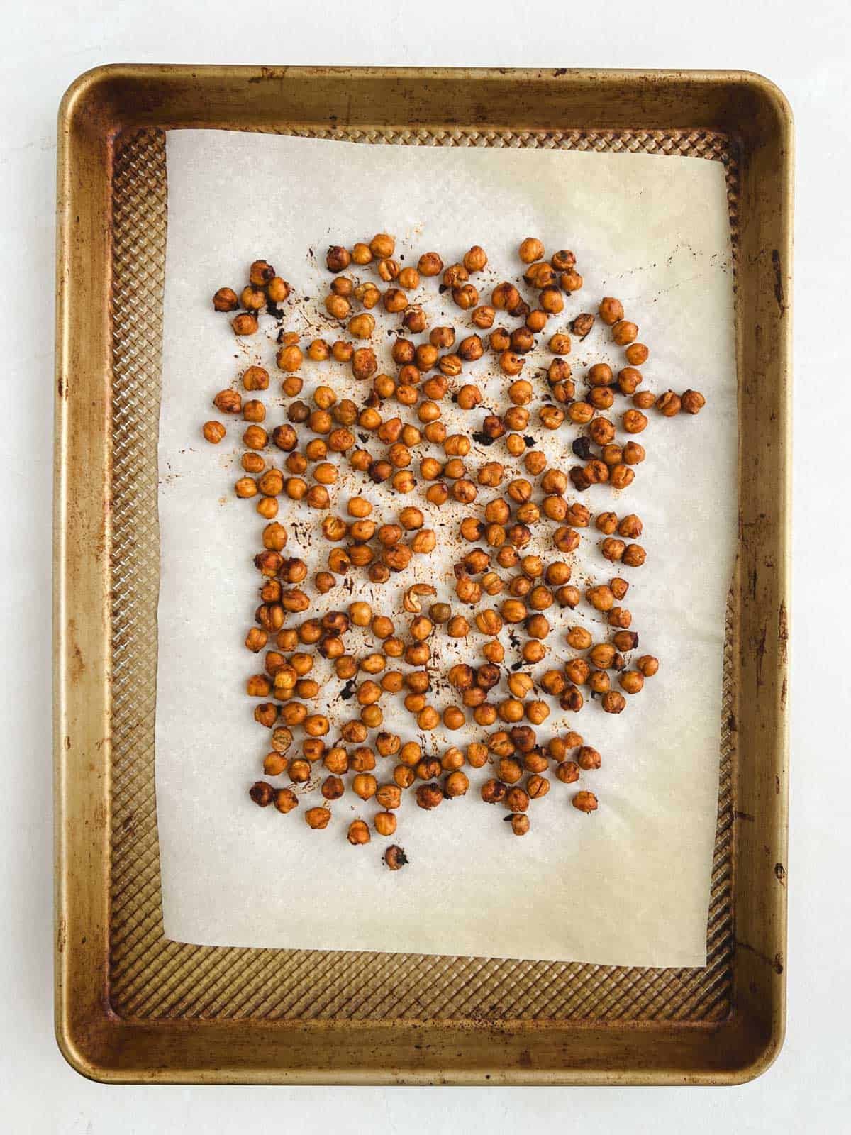 overhead view of prepared baking sheet containing oven-roasted harissa chickpeas