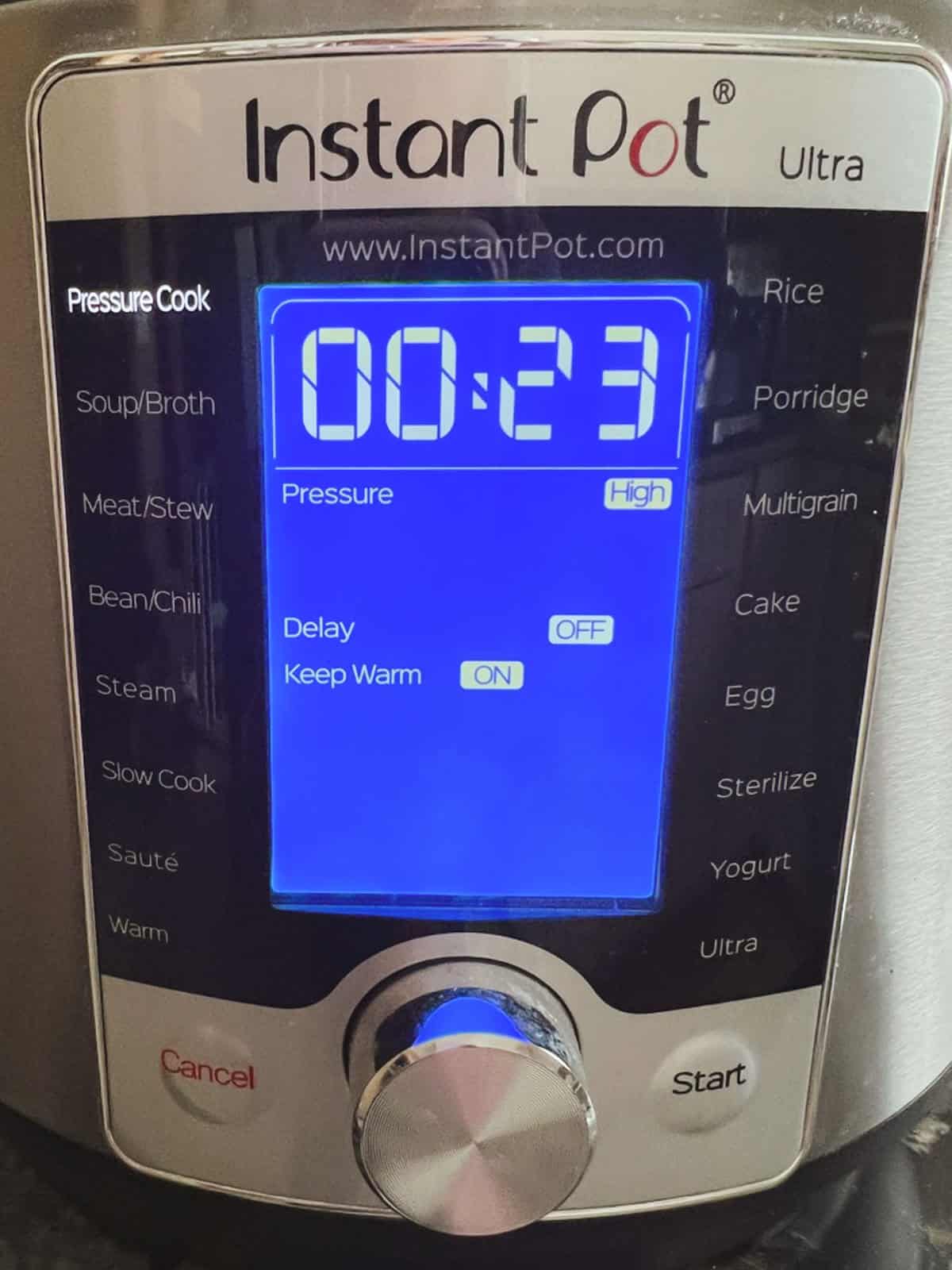 display panel of Instant Pot showing Pressure Cook on high setting for 23 minutes