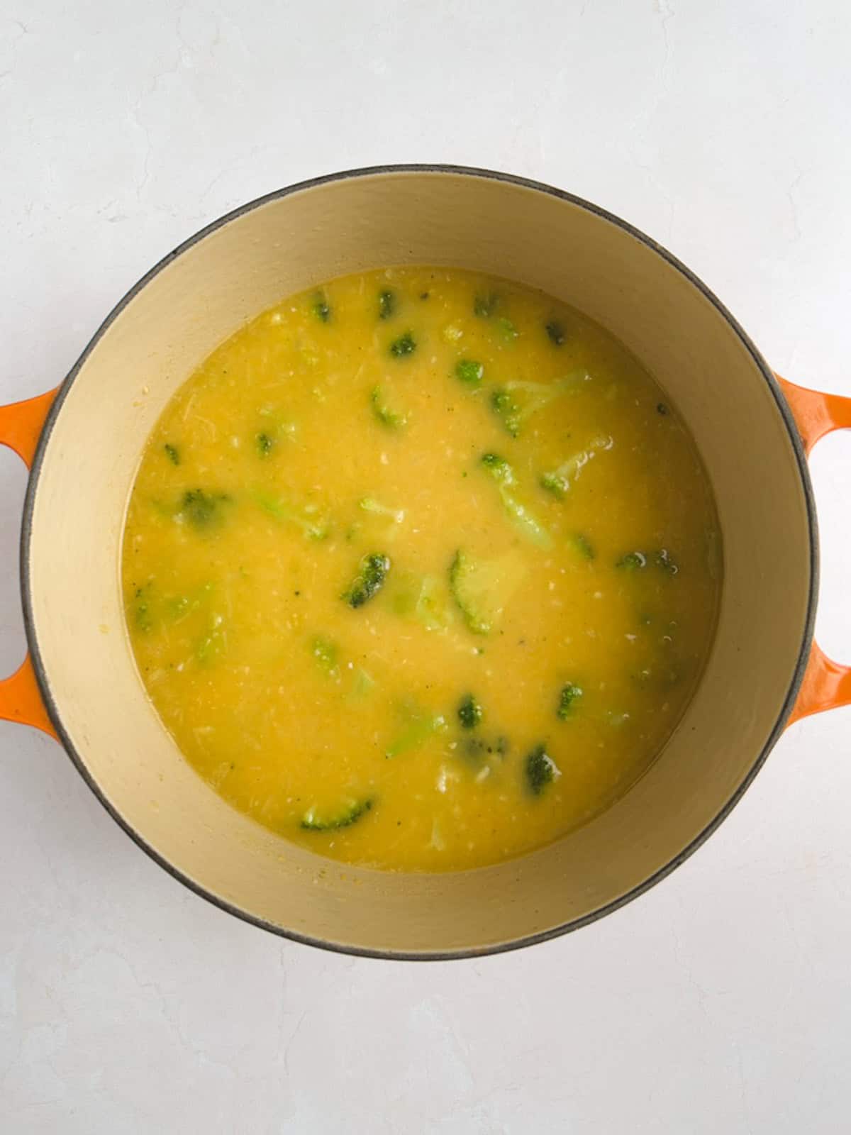 overhead view of Dutch oven containing vegan broccoli cheddar soup