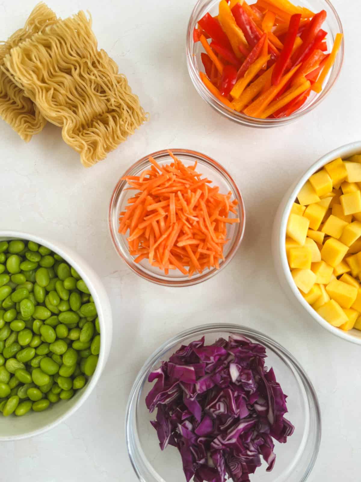 bowls of ingredients for noodle salad