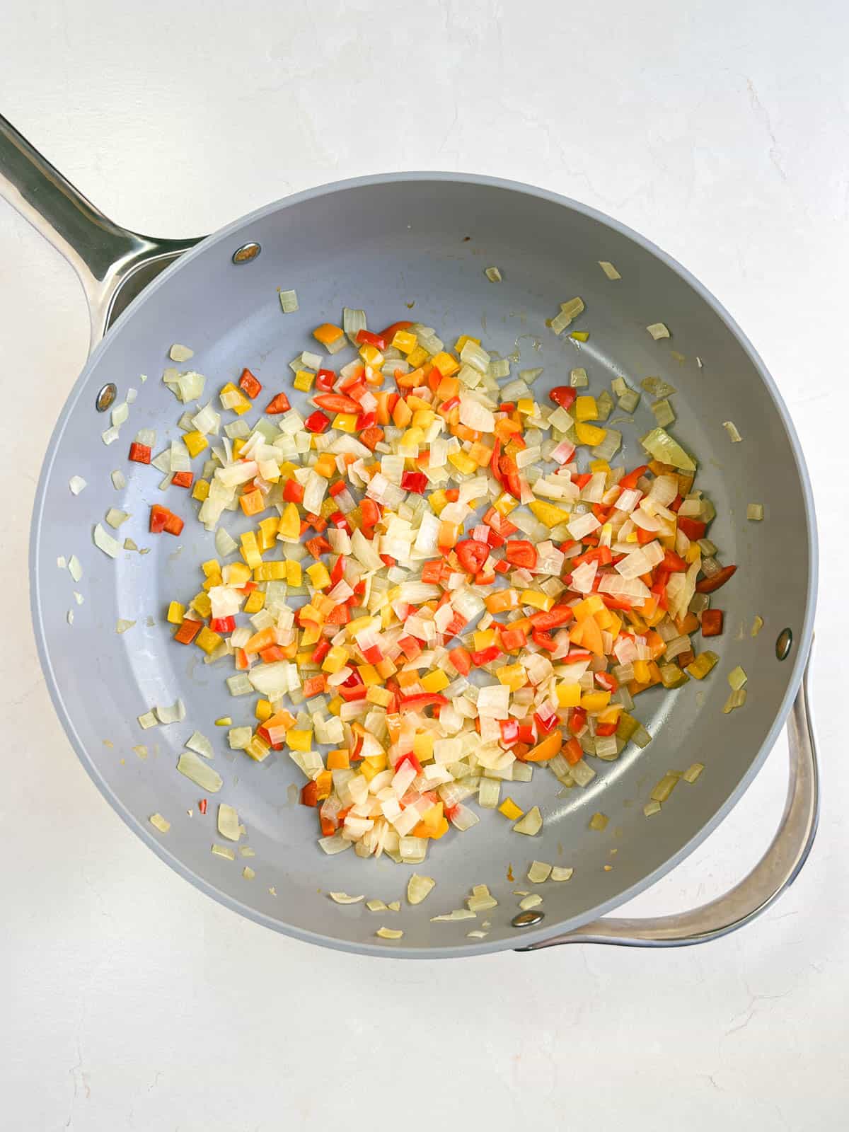 onions and peppers in a skillet