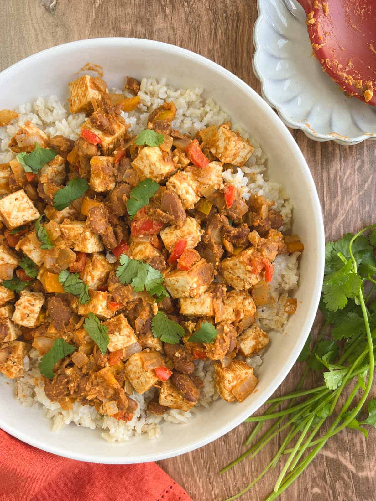 bowl containing serving of Tex-Mex skillet supper garnished with fresh cilantro