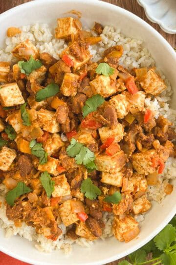bowl of Tex-Mex skillet supper next to fresh cilantro leaves