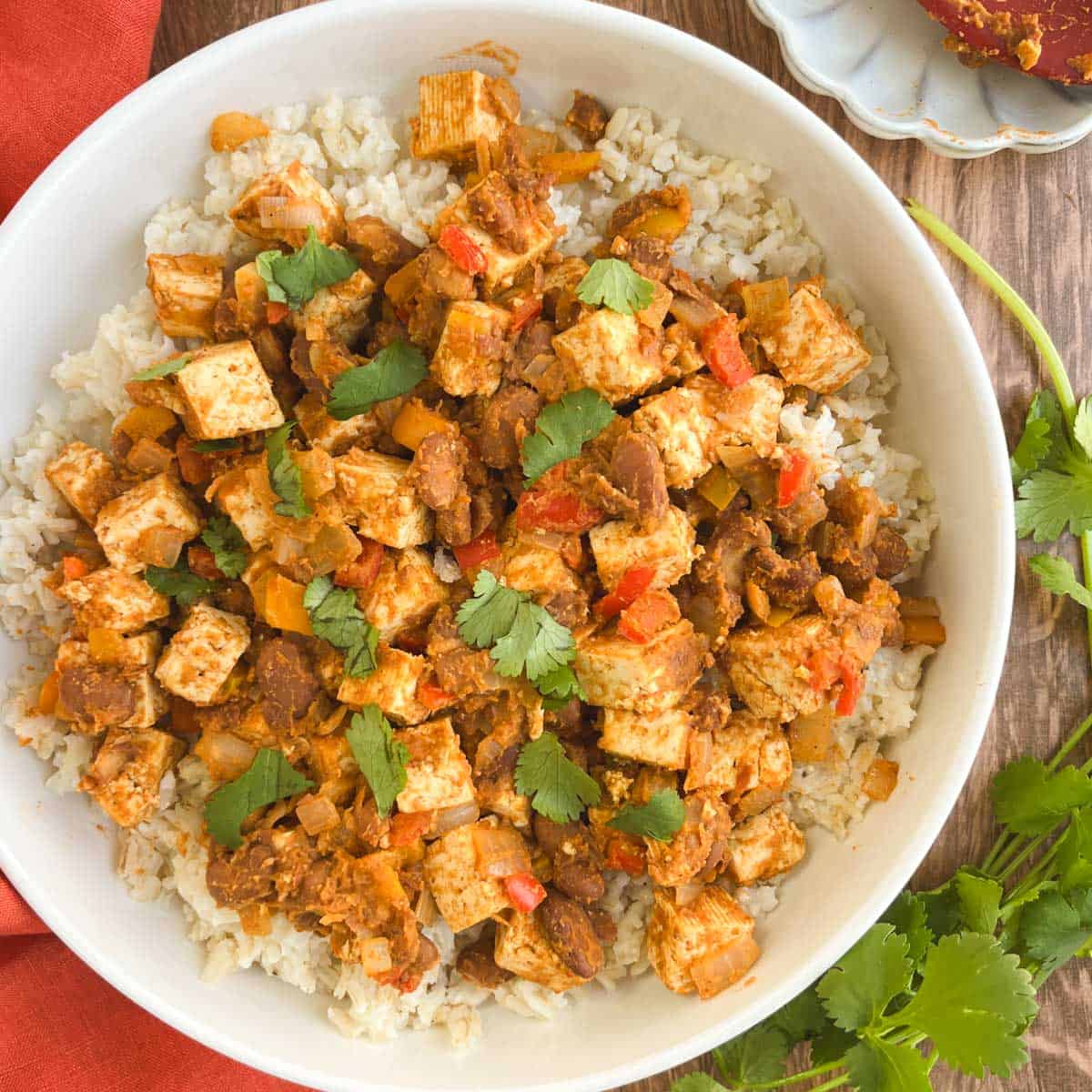 bowl of Tex-Mex skillet supper next to fresh cilantro leaves