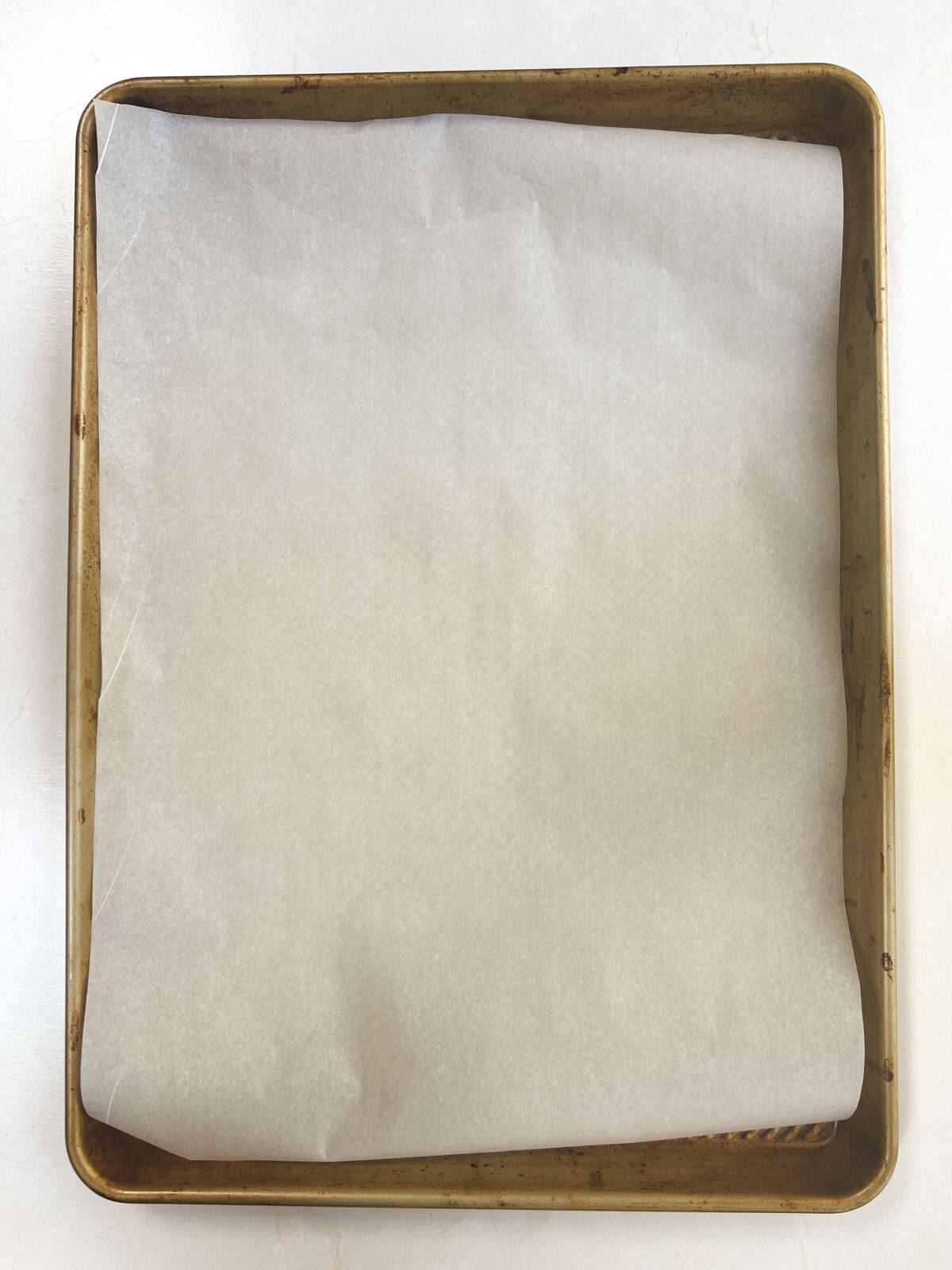 A square of parchment paper on a baking sheet