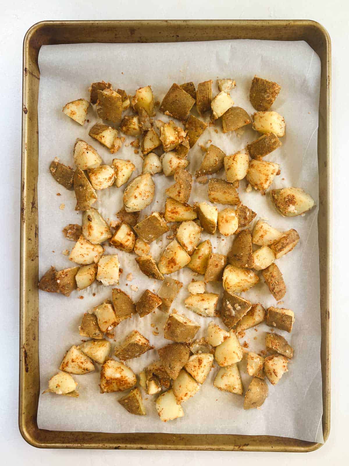 seasoned potatoes on a baking sheet