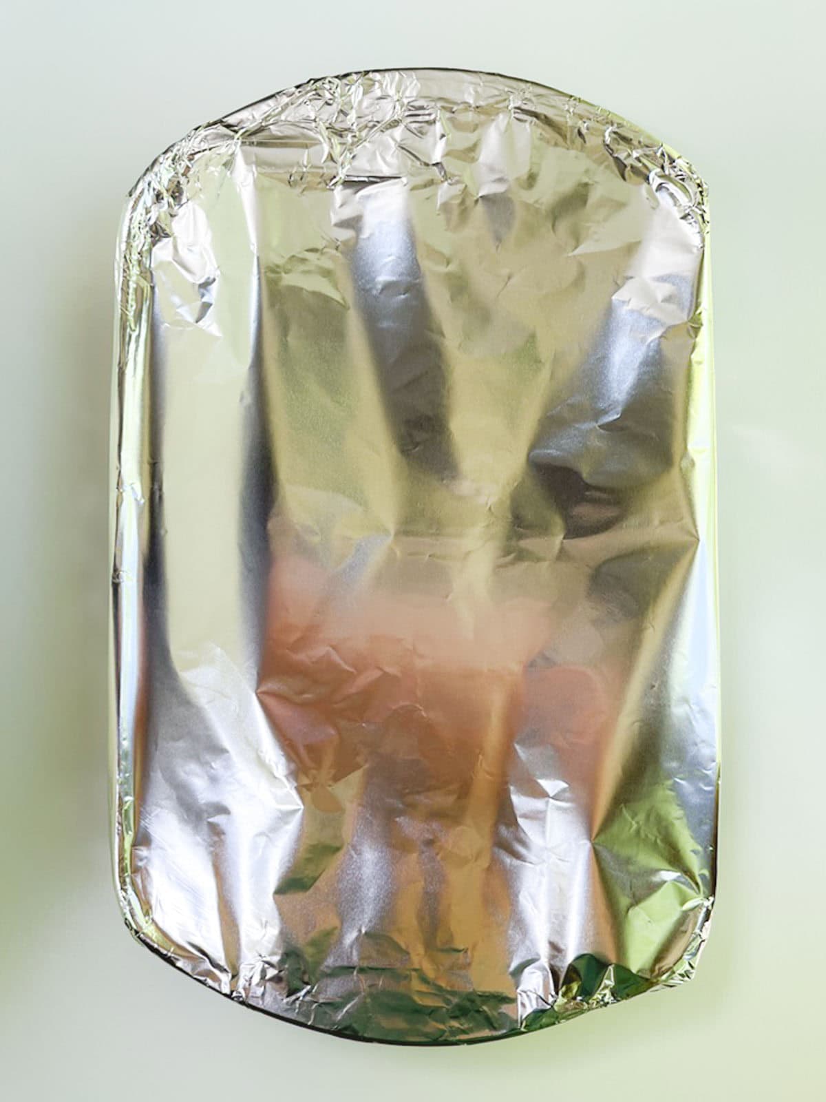 A casserole dish covered with aluminum foil