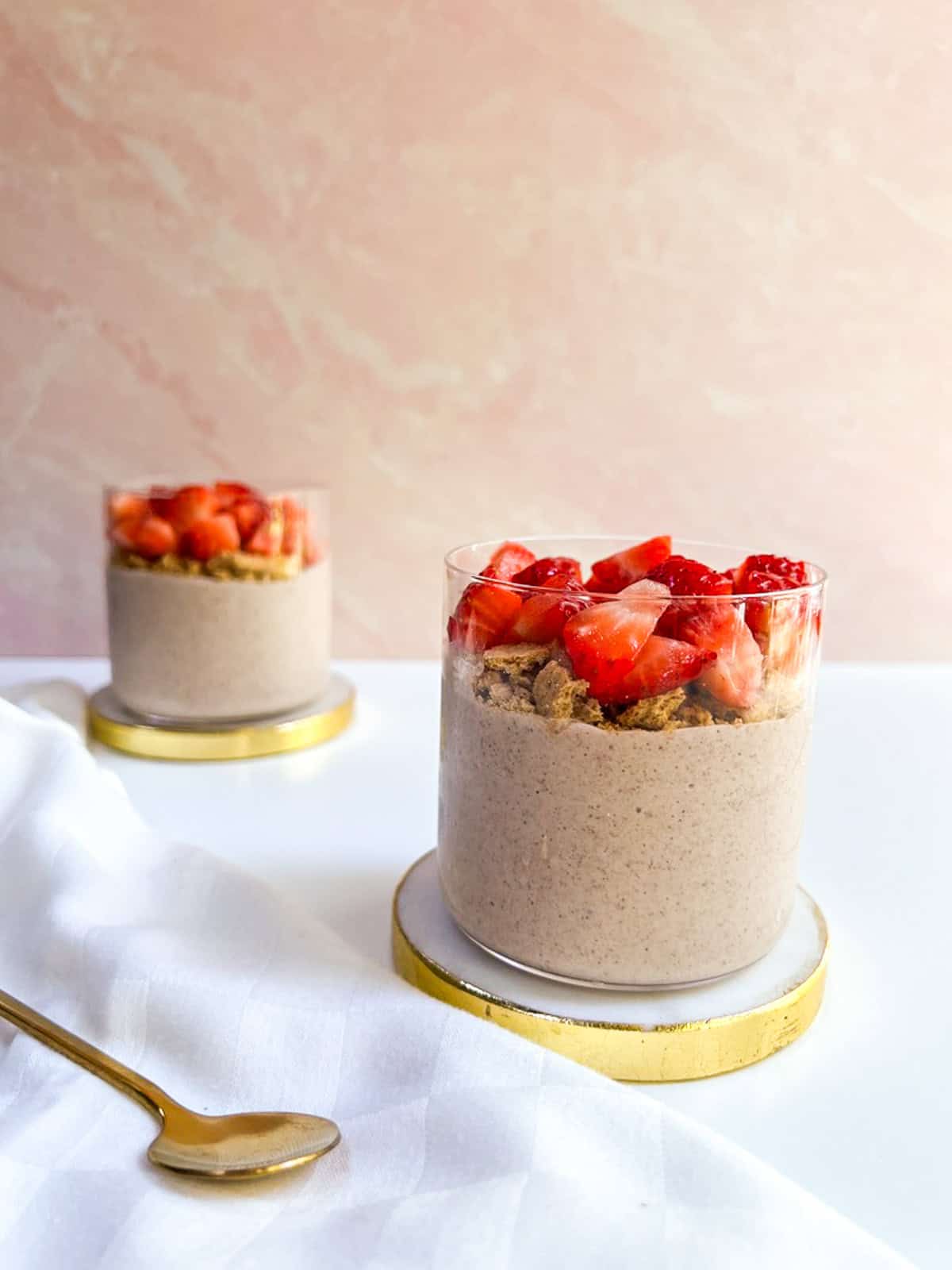 Two small glasses with strawberry overnight oats.