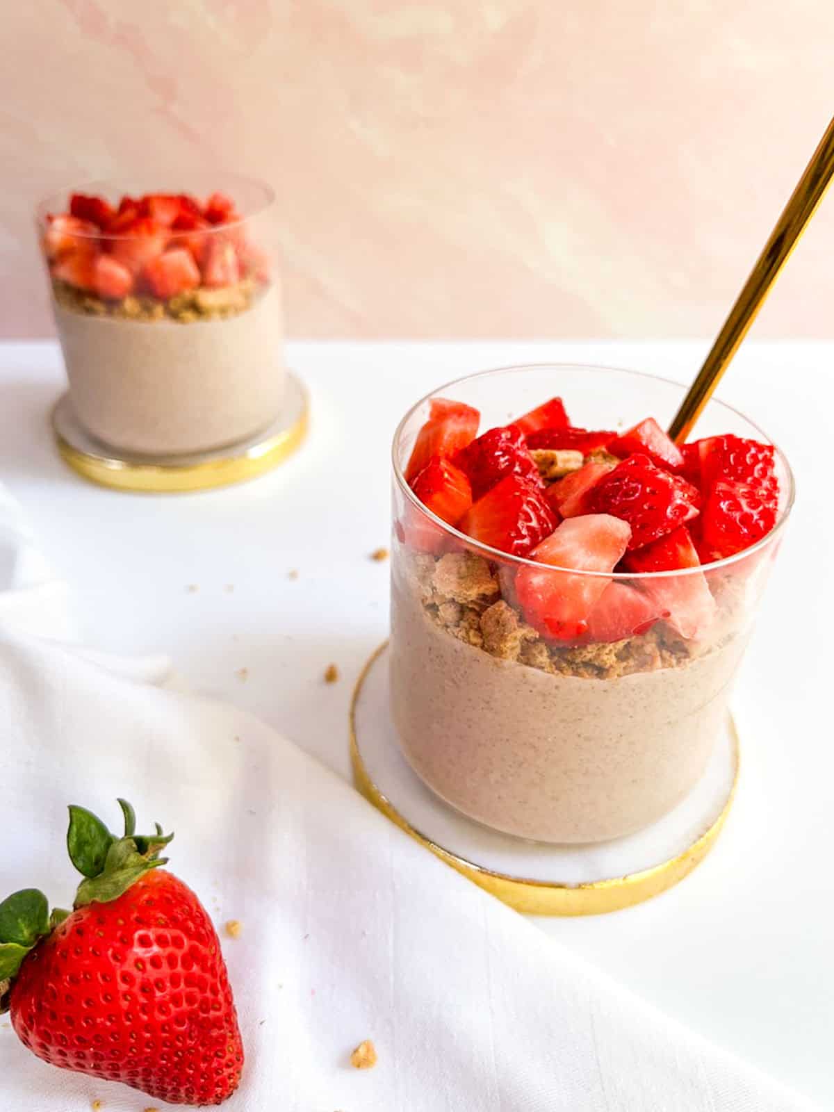 Strawberry overnight oats topped with crushed graham crackers and strawberries.
