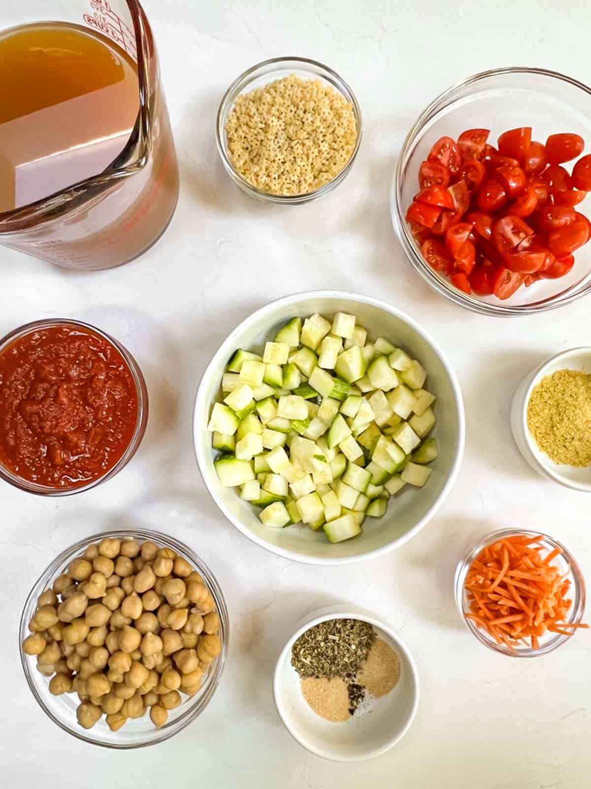 The ingredients for minestrone soup laid out on a table.