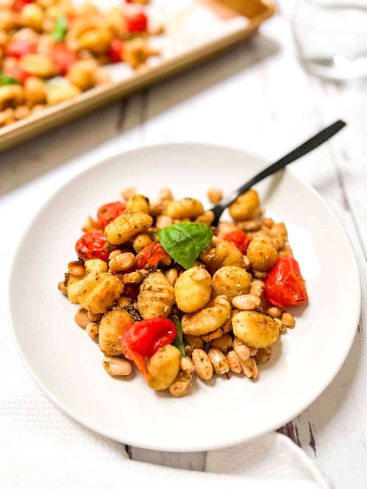 Roasted gnocchi with tomatoes and basil.