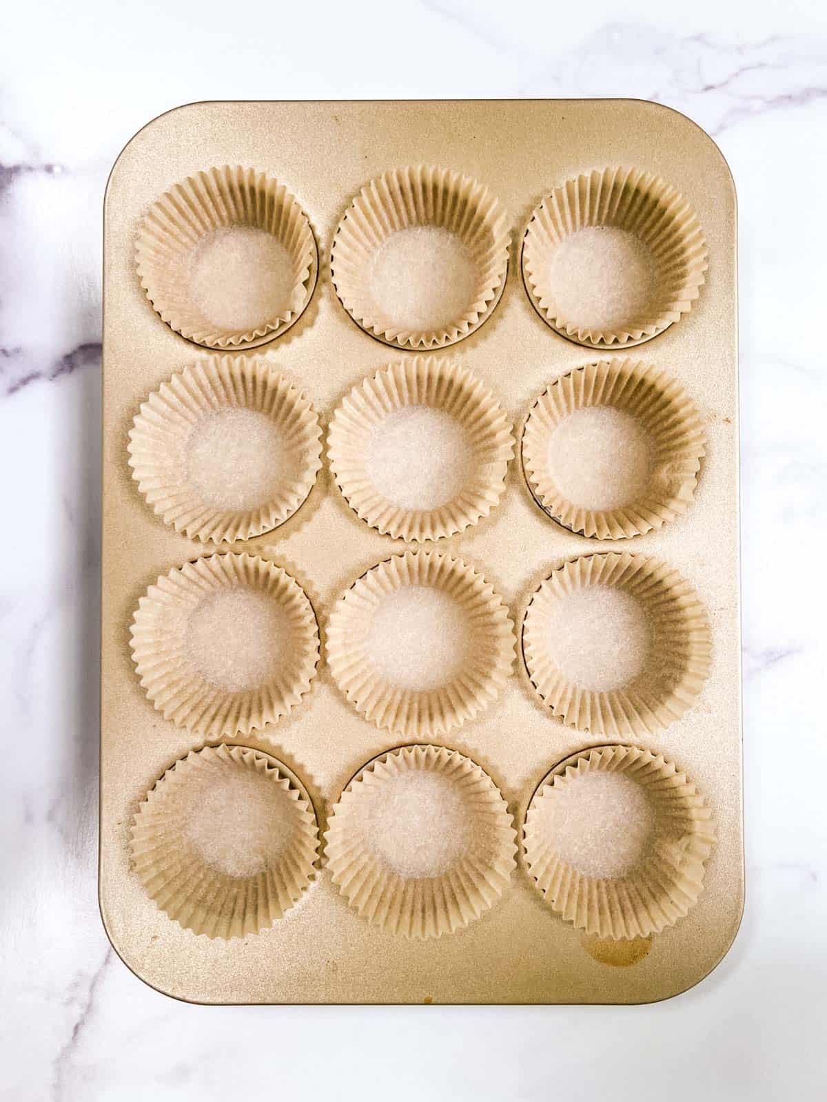 A muffin pan filled with muffin cups.