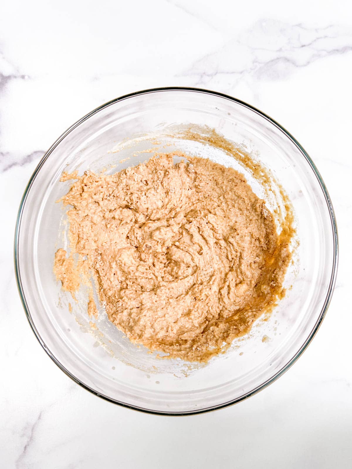 A bowl of batter on a marble counter.