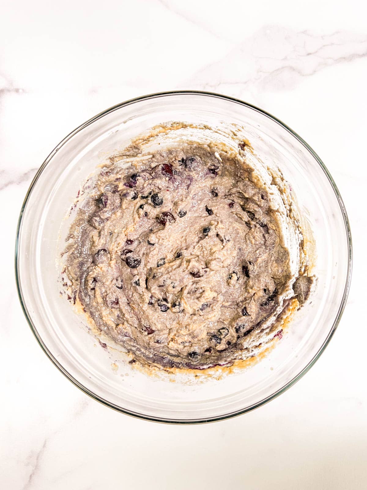 A bowl of blueberry muffin batter.