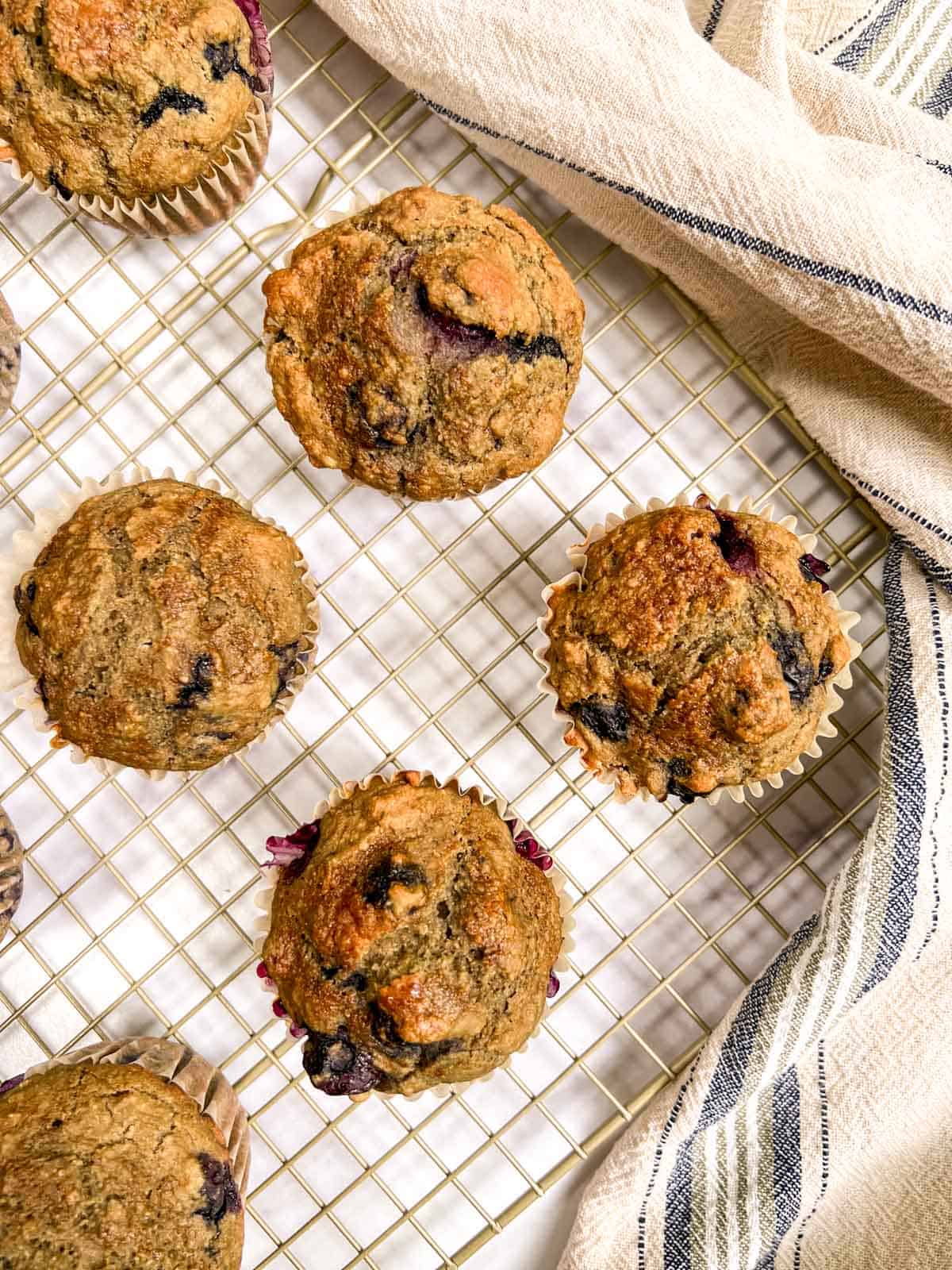 Blueberry muffins on a cooling rack.